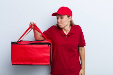 young adult blonde woman shrugging, feeling confused and uncertain. pizza delivery concept