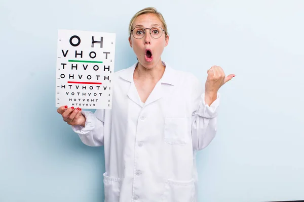 Young Adult Blonde Woman Looking Astonished Disbelief Optical Vision Test — Stockfoto