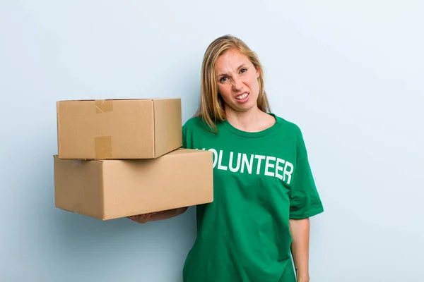 Young Adult Blonde Woman Feeling Puzzled Confused Volunteer Donation Concept — Stockfoto