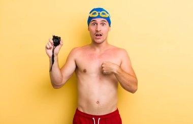 Şok olmuş ve ağzı açık, kendini işaret eden genç ve yakışıklı bir adam. yüzücü kavramı