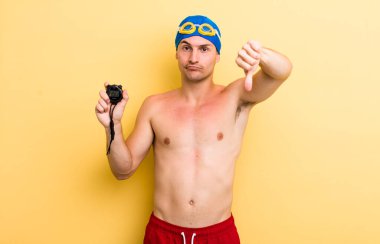 Genç ve yakışıklı adam kendini kötü hissediyor, baş parmağını kaldırıyor. yüzücü kavramı