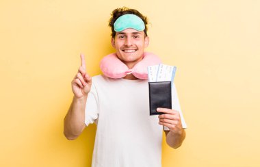 Genç yakışıklı adam gülümsüyor ve arkadaş canlısı görünüyor, bir numarayı gösteriyor. uçuş yolcu kavramı