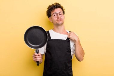 Genç yakışıklı, stresli, endişeli, yorgun ve hayal kırıklığına uğramış hissediyor. Şefin tava konsepti.