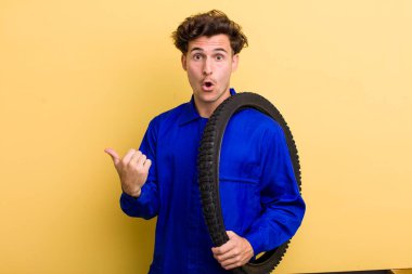 Genç ve yakışıklı bir adam inançsızlığa şaşırmış görünüyor. motor mekaniği kavramı