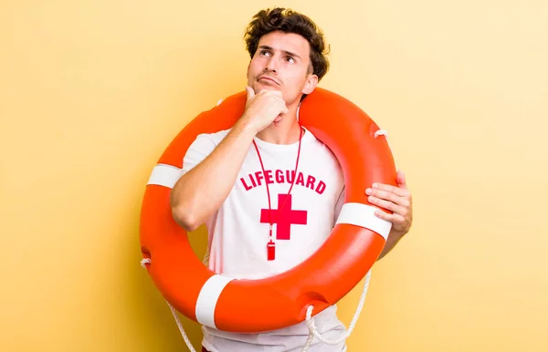 young handsome guy thinking, feeling doubtful and confused. lifeguard concept