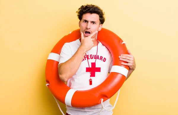 Young Handsome Guy Mouth Eyes Wide Open Hand Chin Lifeguard — Stock Photo, Image