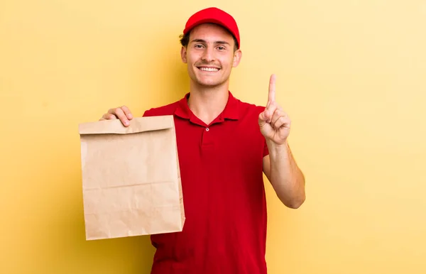 Young Handsome Guy Smiling Looking Friendly Showing Number One Delivery — Stockfoto