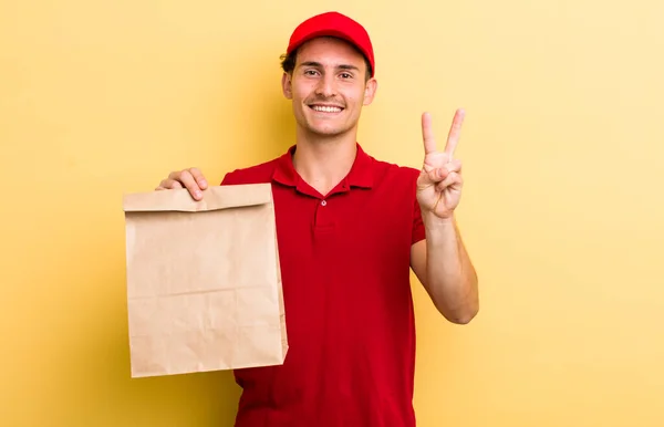 Young Handsome Guy Smiling Looking Friendly Showing Number Two Delivery — Stockfoto