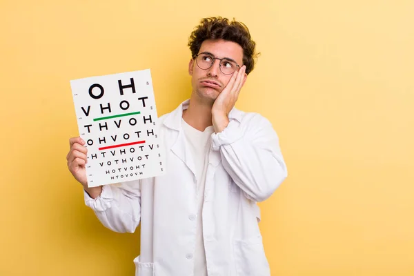 young handsome guy feeling bored, frustrated and sleepy after a tiresome. optical vision test concept