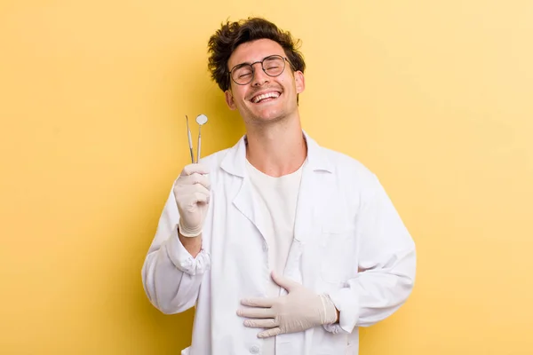 何か陽気な冗談で大声で笑ってる若いハンサムな男 歯科医のコンセプト — ストック写真