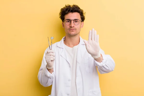 Young Handsome Guy Looking Serious Showing Open Palm Making Stop — Stockfoto