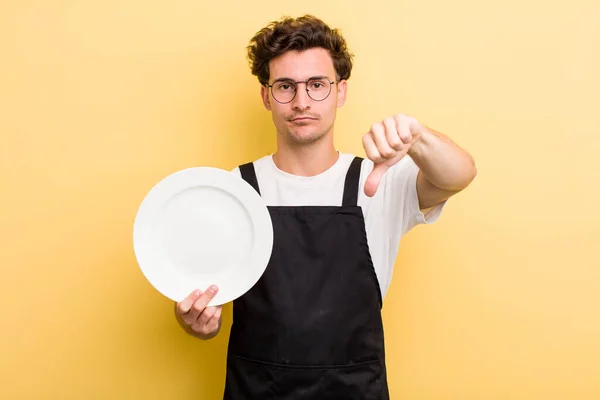 Young Handsome Guy Feeling Cross Showing Thumbs Empty Dish Concept — Stock Photo, Image