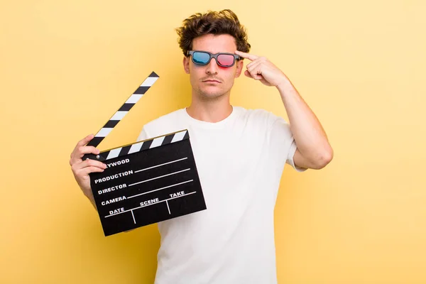 Young Handsome Guy Feeling Confused Puzzled Showing You Insane Movie — Stockfoto