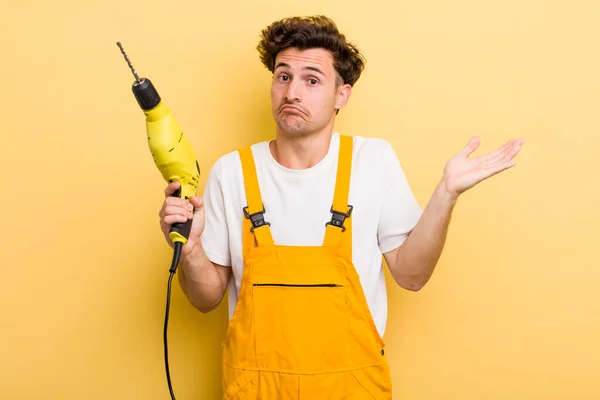 Young Handsome Guy Feeling Puzzled Confused Doubting Handyman Drill Concept — Stock Photo, Image