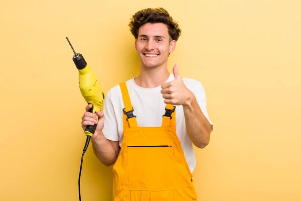 Young Handsome Guy Feeling Proud Smiling Positively Thumbs Handyman Drill — Stockfoto