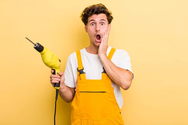 Young Handsome Guy Feeling Shocked Scared Handyman Drill Concept — Stock Photo, Image