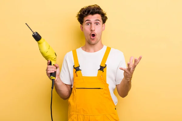 Young Handsome Guy Amazed Shocked Astonished Unbelievable Surprise Handyman Drill — Stock Photo, Image