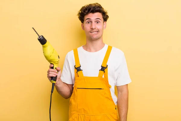 Young Handsome Guy Looking Puzzled Confused Handyman Drill Concept — Stock Photo, Image