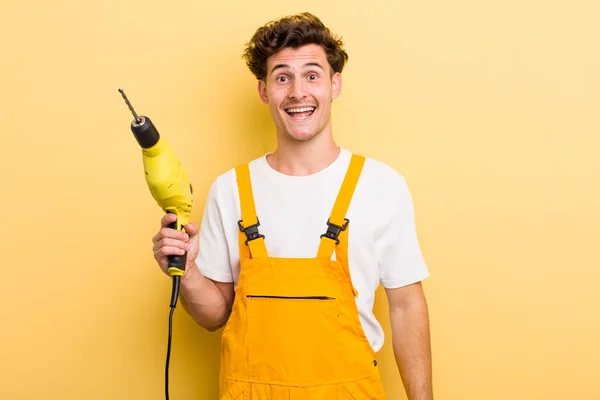 Young Handsome Guy Looking Happy Pleasantly Surprised Handyman Drill Concept — Stock Photo, Image