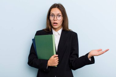 young adult woman amazed, shocked and astonished with an unbelievable surprise. university student concept