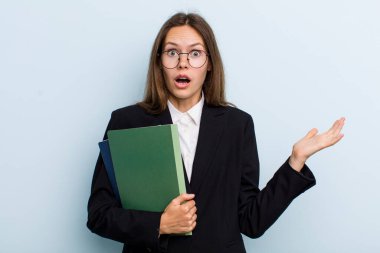 young adult woman feeling extremely shocked and surprised. university student concept