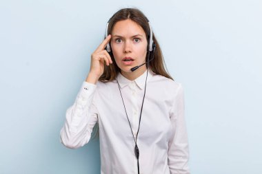 young adult woman looking surprised, realizing a new thought, idea or concept. telemarketer concept