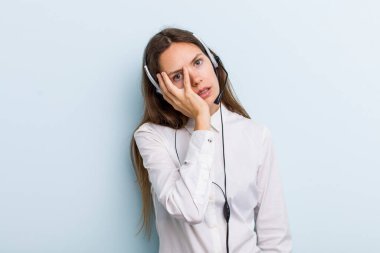 young adult woman feeling bored, frustrated and sleepy after a tiresome. telemarketer concept