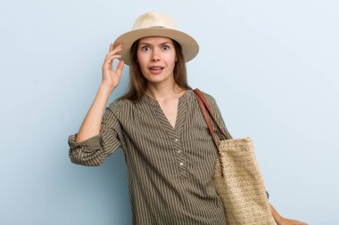 young adult woman looking happy, astonished and surprised. summer concept