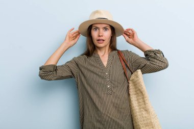 young adult woman feeling stressed, anxious or scared, with hands on head. summer concept