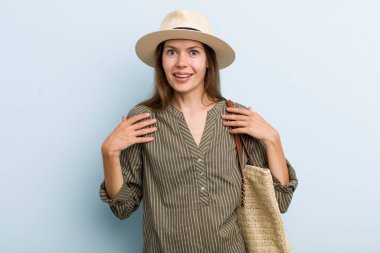 young adult woman feeling happy and pointing to self with an excited. summer concept