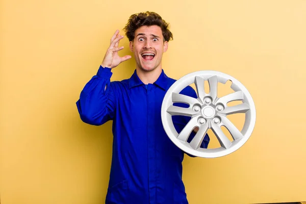 Young Handsome Teenager Screaming Hands Air Car Mechanic Concept — Stockfoto