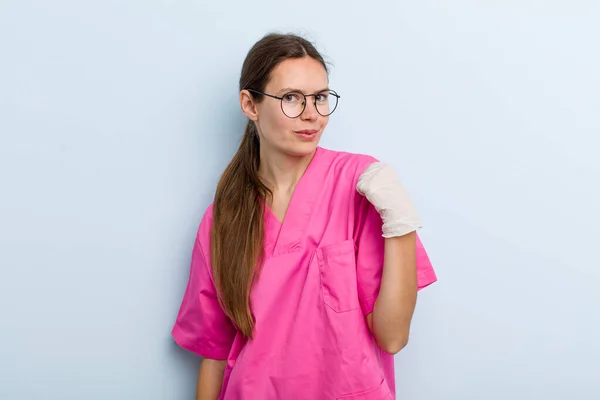 young adult woman looking arrogant, successful, positive and proud. nurse concept