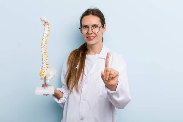 Young Adult Woman Smiling Proudly Confidently Making Number One Spine — Stockfoto