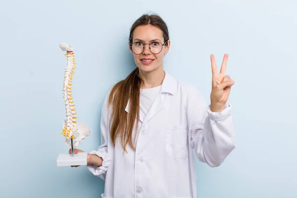 Young Adult Woman Smiling Looking Friendly Showing Number Two Spine — Stockfoto