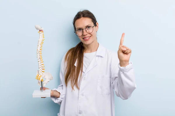 Young Adult Woman Smiling Looking Friendly Showing Number One Spine — Zdjęcie stockowe