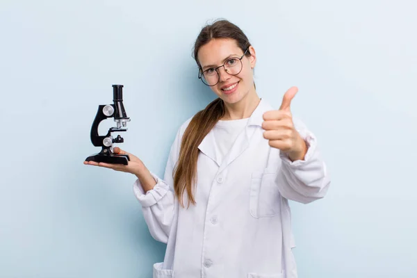 Young Adult Woman Feeling Proud Smiling Positively Thumbs Scientist Microscope — Stok fotoğraf