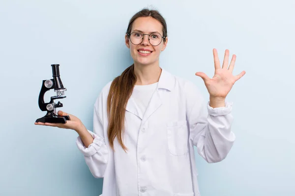 Young Adult Woman Smiling Looking Friendly Showing Number Five Scientist — Stockfoto