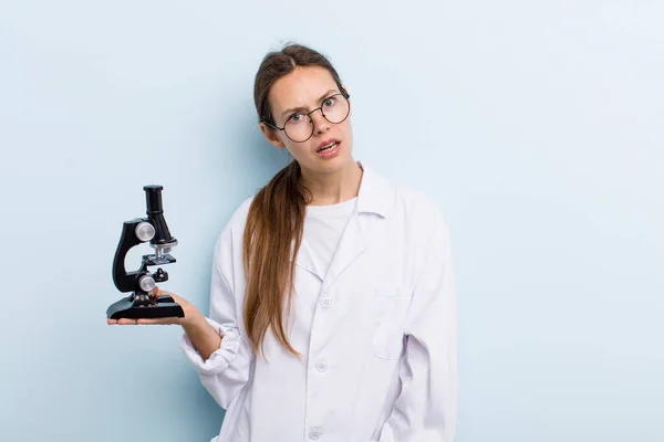 Young Adult Woman Feeling Puzzled Confused Scientist Microscope — Stockfoto