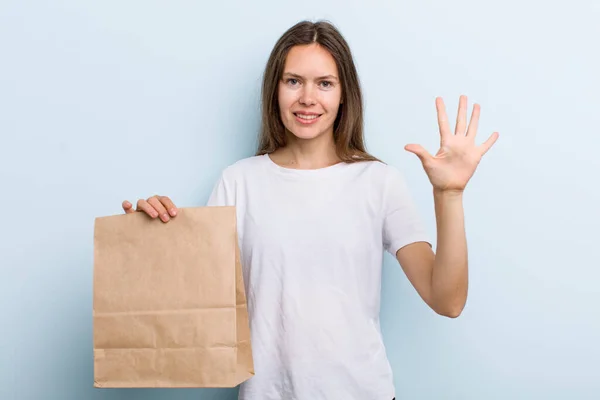 Young Adult Woman Smiling Looking Friendly Showing Number Five Delivery — Stock fotografie