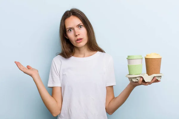 Young Adult Woman Looking Surprised Shocked Jaw Dropped Holding Object — Stockfoto