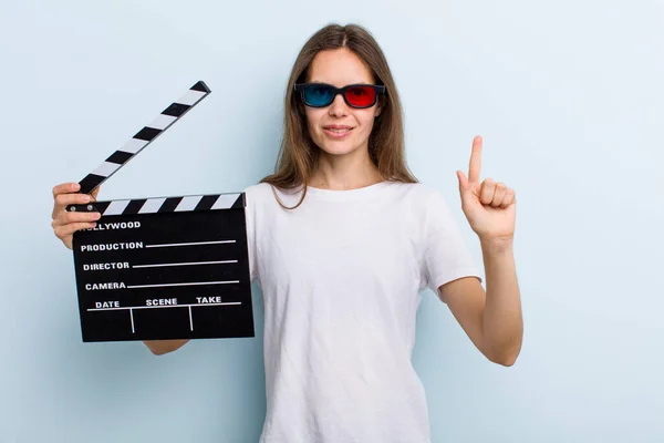 Young Adult Woman Smiling Looking Friendly Showing Number One Movie — Stockfoto