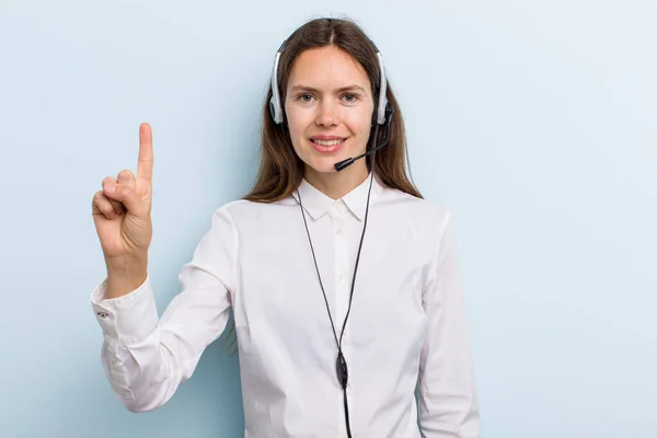 Young Adult Woman Smiling Looking Friendly Showing Number One Telemarketer — 图库照片