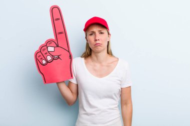 blonde young adult woman feeling sad and whiney with an unhappy look and crying. number one fan concept