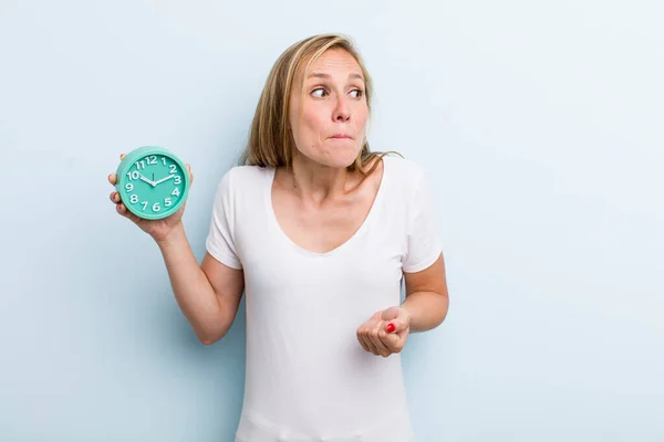 Blonde Young Adult Woman Shrugging Feeling Confused Uncertain Alarm Clock — Stockfoto