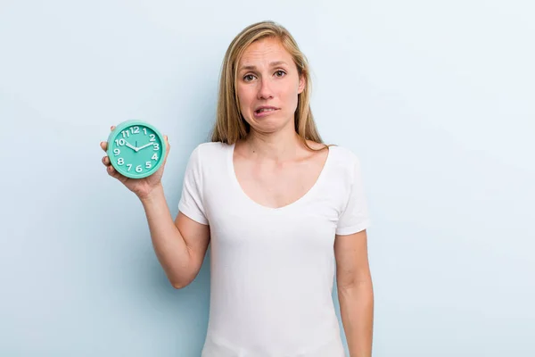 Blonde Young Adult Woman Looking Puzzled Confused Alarm Clock Concept — Stock Fotó