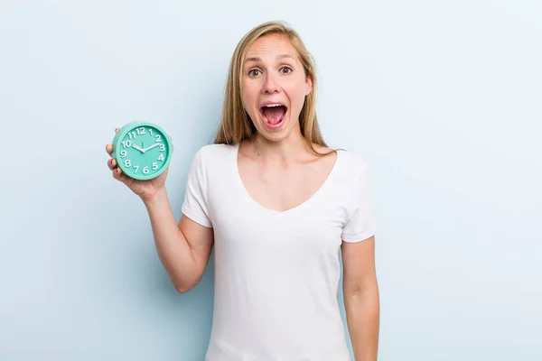 Blonde Young Adult Woman Looking Happy Pleasantly Surprised Alarm Clock — Foto de Stock