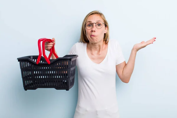 Blonde Young Adult Woman Feeling Puzzled Confused Doubting Shopping Basket — Foto Stock