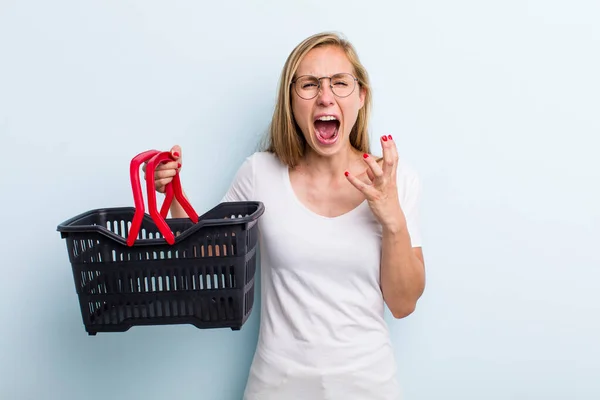 Blonde Young Adult Woman Looking Desperate Frustrated Stressed Shopping Basket — Stockfoto