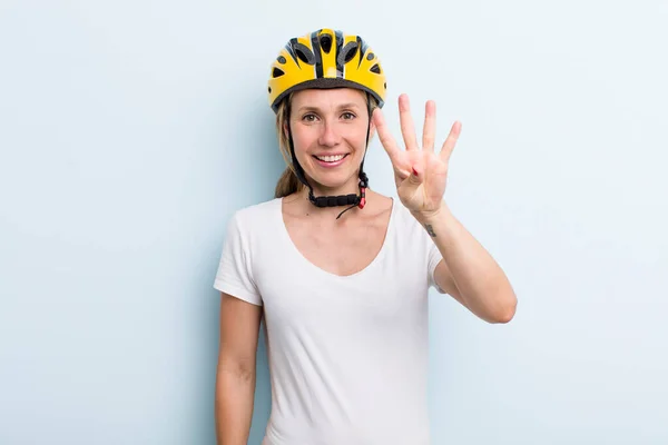 Blonde Young Adult Woman Smiling Looking Friendly Showing Number Four — Zdjęcie stockowe