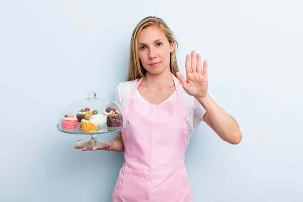 Blonde Young Adult Woman Looking Serious Showing Open Palm Making — Stockfoto